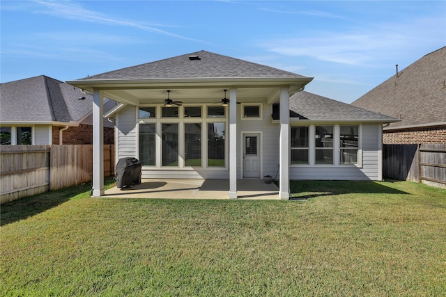 rear view of property featuring a yard, a shingled roof, a patio area, ceiling fan, and a fenced backyard