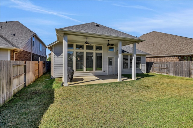 rear view of house with a ceiling fan, a patio area, a fenced backyard, and a yard