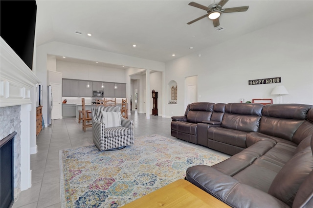 living room with a fireplace, light tile patterned floors, recessed lighting, visible vents, and a ceiling fan