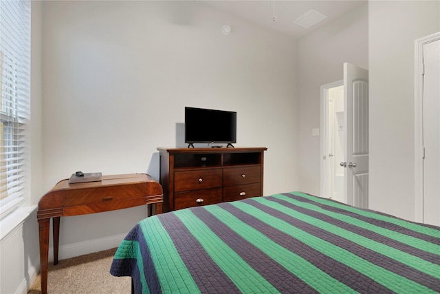 carpeted bedroom featuring baseboards