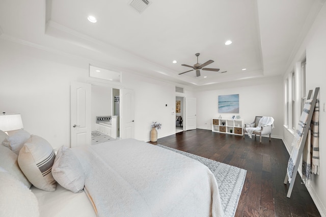 bedroom with hardwood / wood-style floors, ornamental molding, a raised ceiling, and ceiling fan