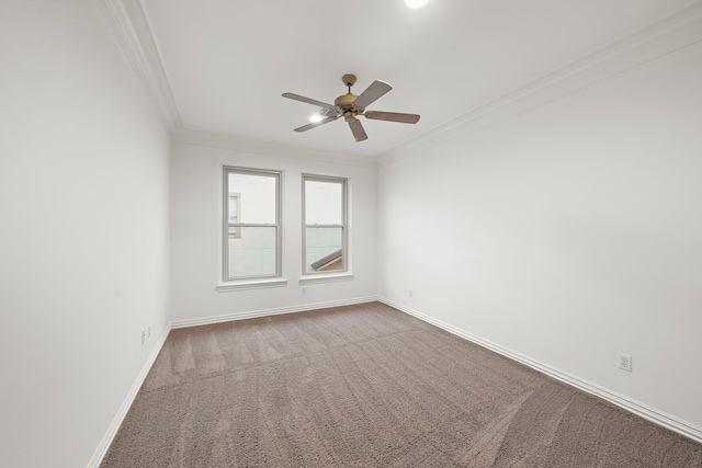 carpeted spare room with crown molding and ceiling fan