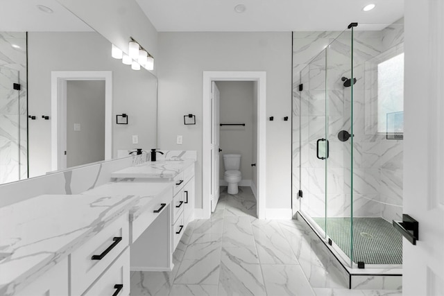 bathroom with vanity, toilet, and an enclosed shower