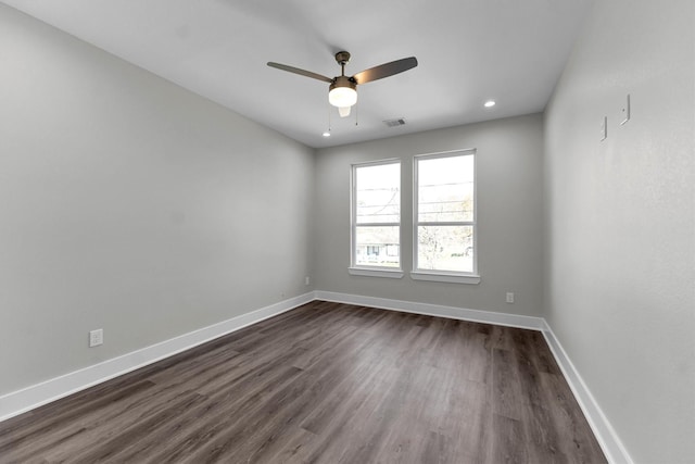 unfurnished room featuring dark wood-type flooring and ceiling fan