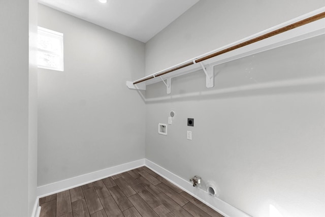 clothes washing area featuring dark hardwood / wood-style flooring, hookup for an electric dryer, hookup for a gas dryer, and hookup for a washing machine