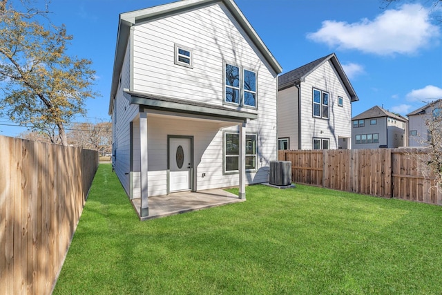 back of property featuring central AC unit, a patio, and a lawn