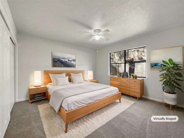 carpeted bedroom featuring ceiling fan, a closet, and a textured ceiling