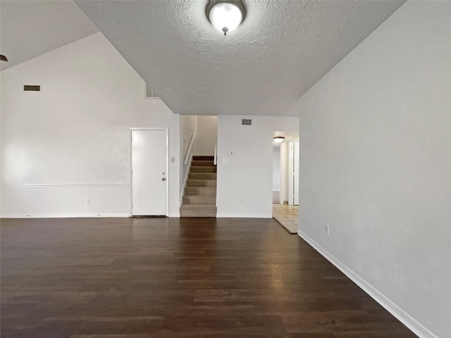 spare room with dark hardwood / wood-style floors and a textured ceiling