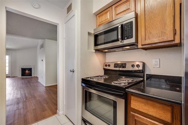 kitchen with appliances with stainless steel finishes and light tile patterned floors