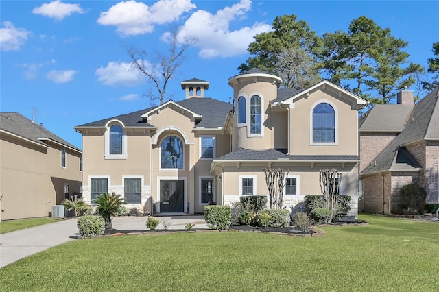 view of front of home with cooling unit and a front lawn