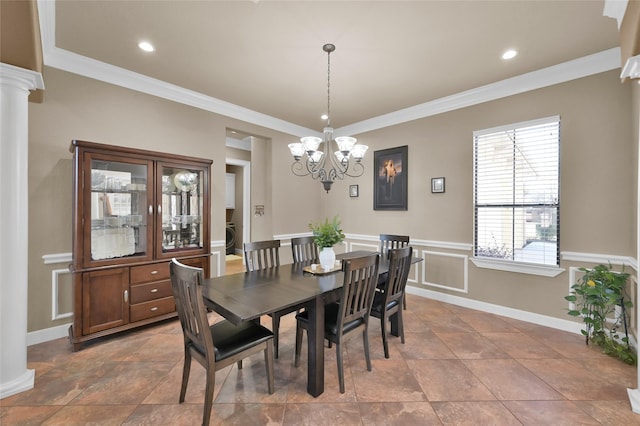 dining room with an inviting chandelier, ornamental molding, and decorative columns