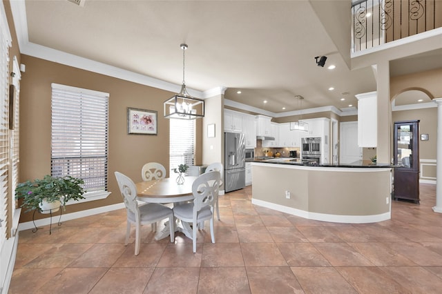 tiled dining space featuring ornamental molding