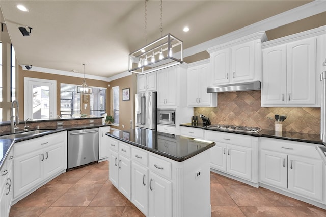 kitchen featuring white cabinetry, appliances with stainless steel finishes, sink, and decorative light fixtures