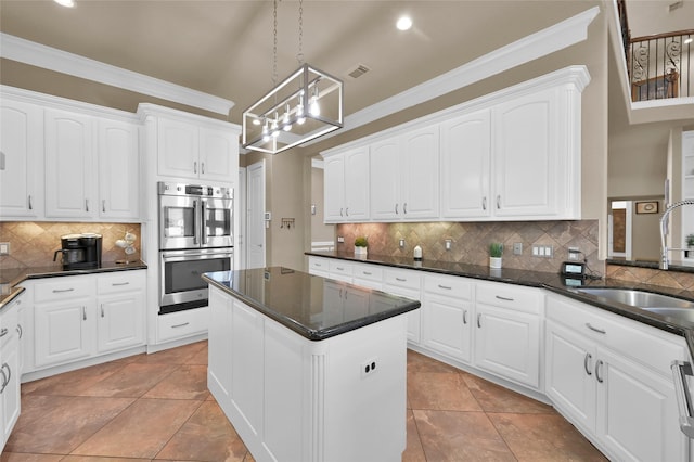 kitchen with pendant lighting, sink, crown molding, white cabinetry, and double oven