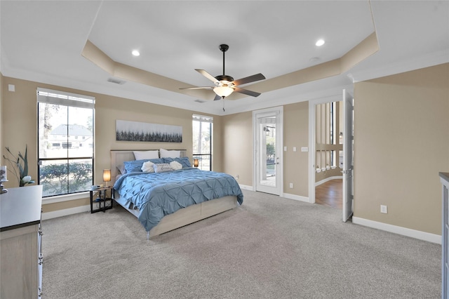 carpeted bedroom featuring a raised ceiling, access to outside, and ceiling fan