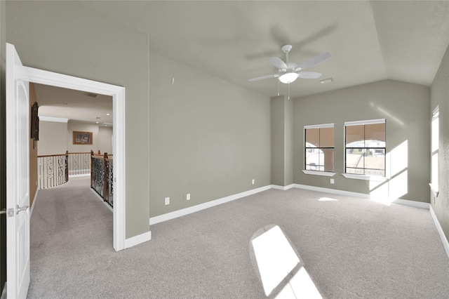 carpeted spare room featuring lofted ceiling and ceiling fan