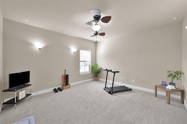 exercise room with light colored carpet and ceiling fan