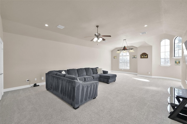 living room featuring ceiling fan, light colored carpet, and vaulted ceiling