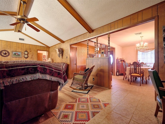 bedroom with a notable chandelier, wooden walls, a textured ceiling, and vaulted ceiling with beams