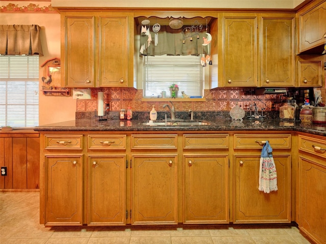 kitchen featuring sink and dark stone counters