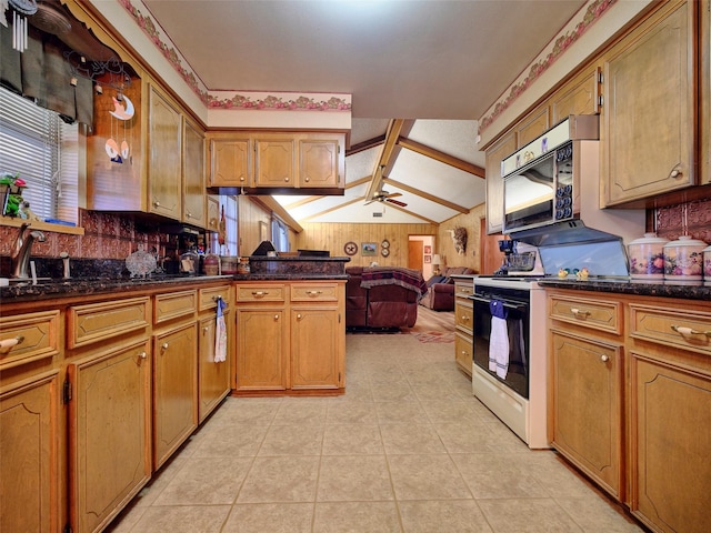 kitchen featuring light tile patterned floors, ceiling fan, white range oven, lofted ceiling with beams, and kitchen peninsula