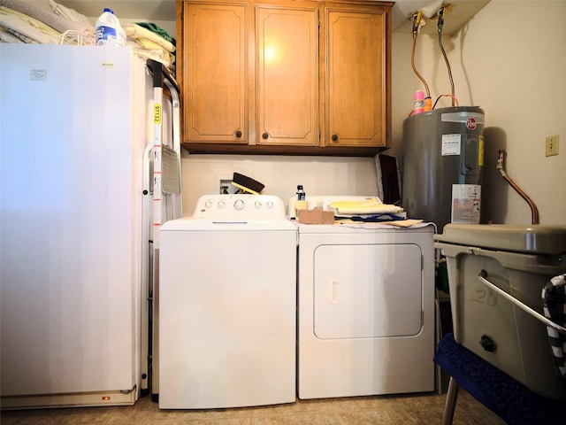 laundry room with cabinets, washing machine and dryer, and electric water heater