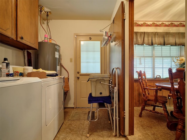 laundry room with cabinets, separate washer and dryer, and water heater