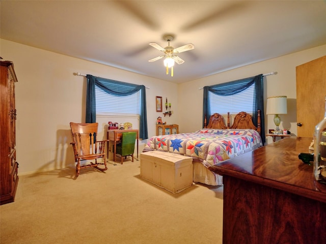 carpeted bedroom featuring multiple windows and ceiling fan