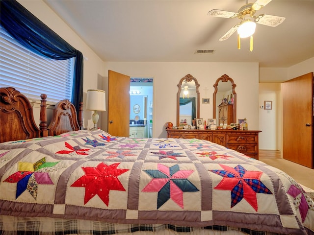 bedroom featuring ceiling fan and ensuite bathroom