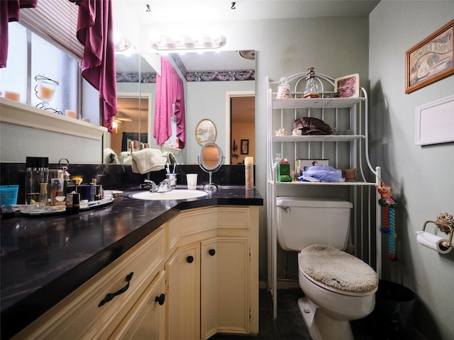 bathroom featuring vanity and toilet