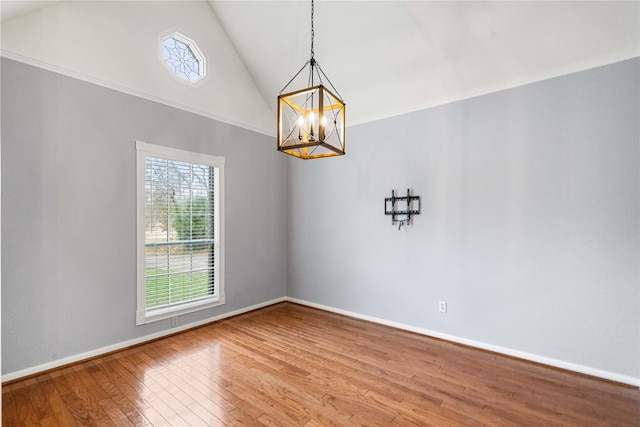 unfurnished dining area with wood-type flooring, high vaulted ceiling, and an inviting chandelier