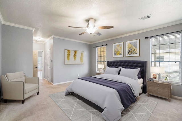 carpeted bedroom featuring ornamental molding, ceiling fan, a textured ceiling, and a closet