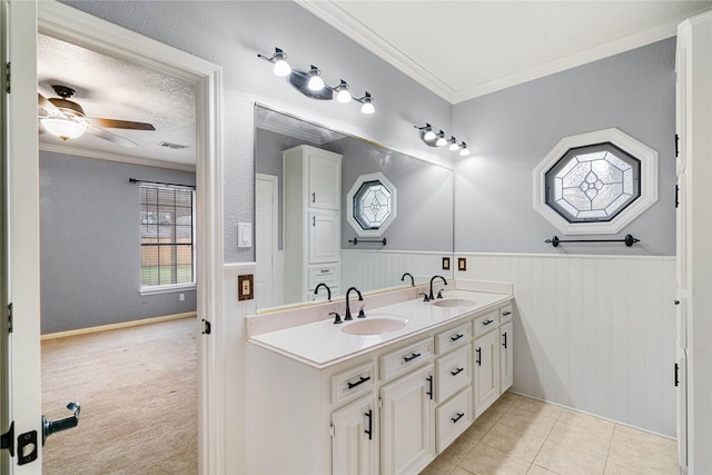 bathroom with tile patterned floors, ceiling fan, ornamental molding, and vanity