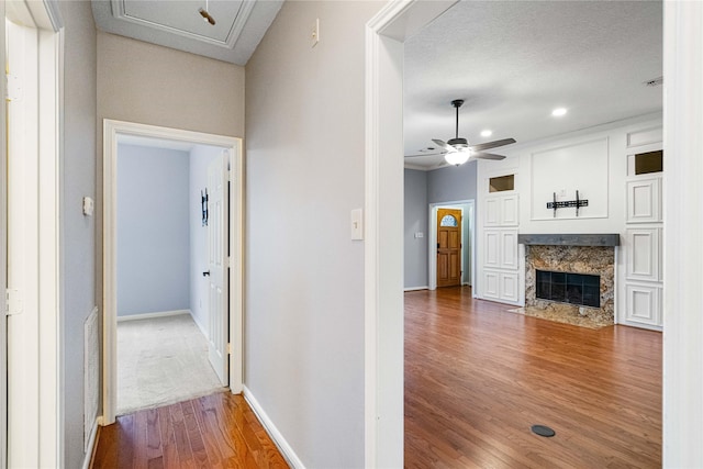 hallway with dark hardwood / wood-style floors and a textured ceiling