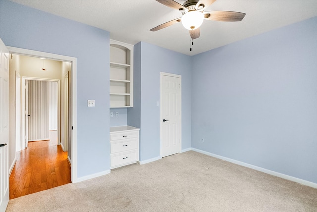 unfurnished bedroom featuring light colored carpet and ceiling fan