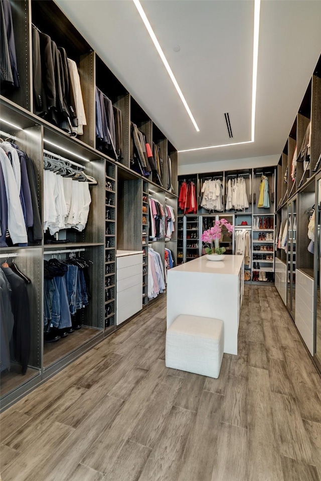 walk in closet featuring light hardwood / wood-style floors