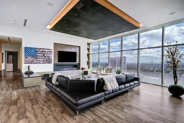 living room featuring a wall of windows and hardwood / wood-style floors