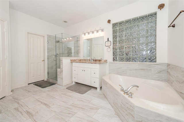 bathroom with independent shower and bath and vanity