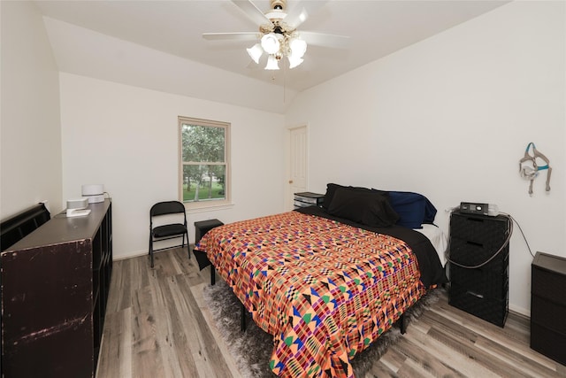 bedroom with vaulted ceiling, hardwood / wood-style floors, and ceiling fan