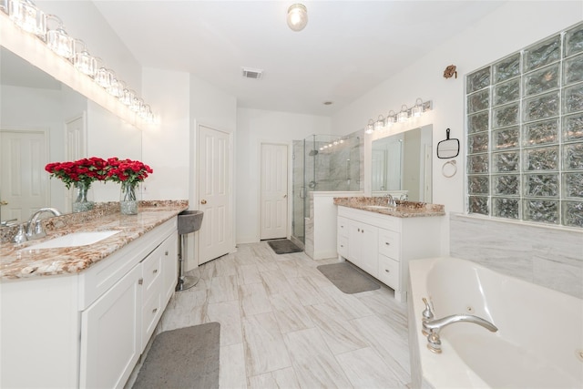 bathroom featuring vanity and plus walk in shower