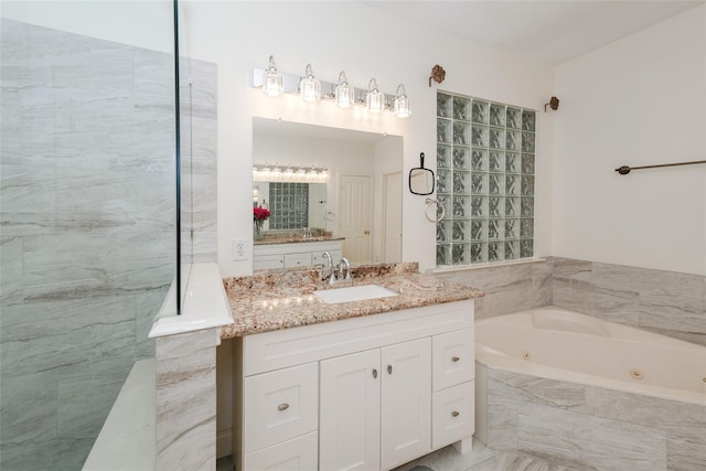 bathroom with vanity and tiled bath