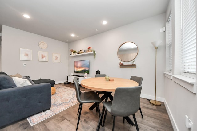 dining space with wood-type flooring