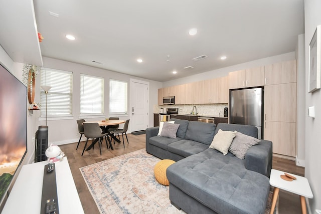 living room with sink and light wood-type flooring