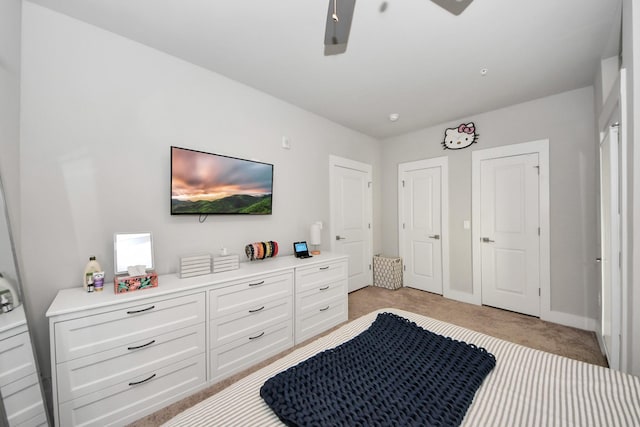 bedroom featuring ceiling fan and light carpet