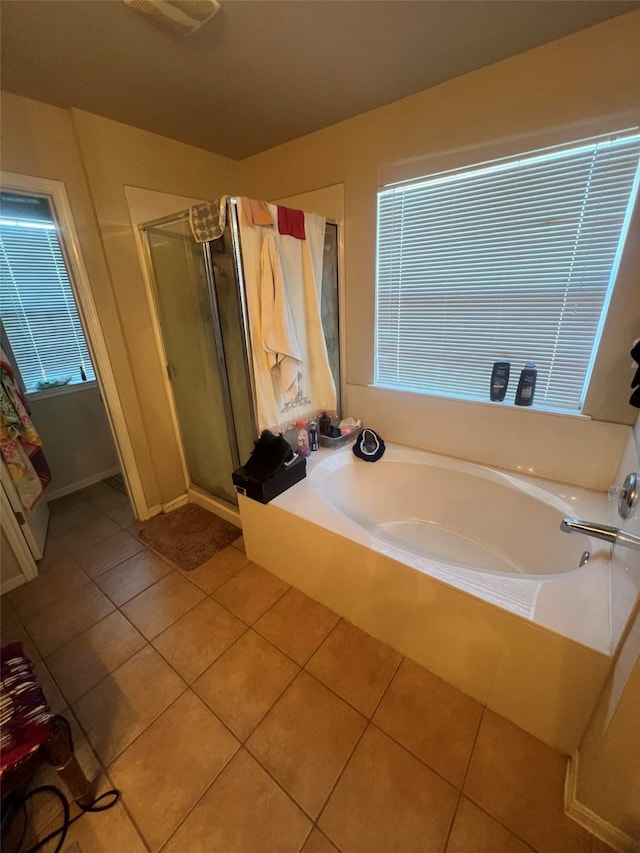 bathroom featuring shower with separate bathtub and tile patterned flooring