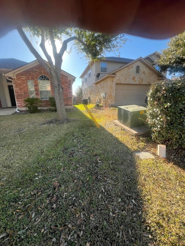 view of property exterior with a garage and a lawn