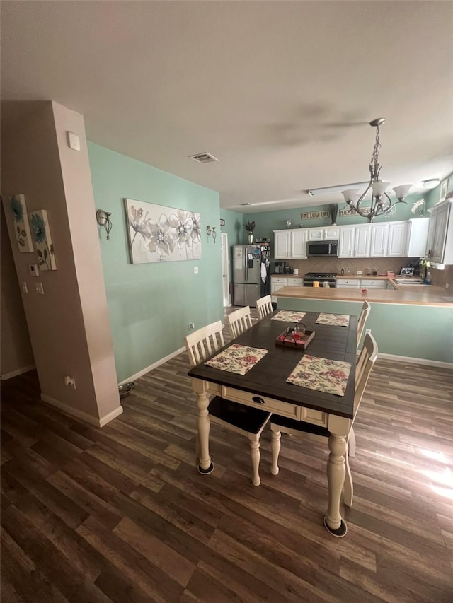 dining area featuring dark hardwood / wood-style flooring