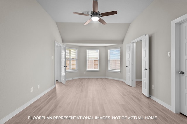 empty room with a ceiling fan, light wood-type flooring, lofted ceiling, and baseboards