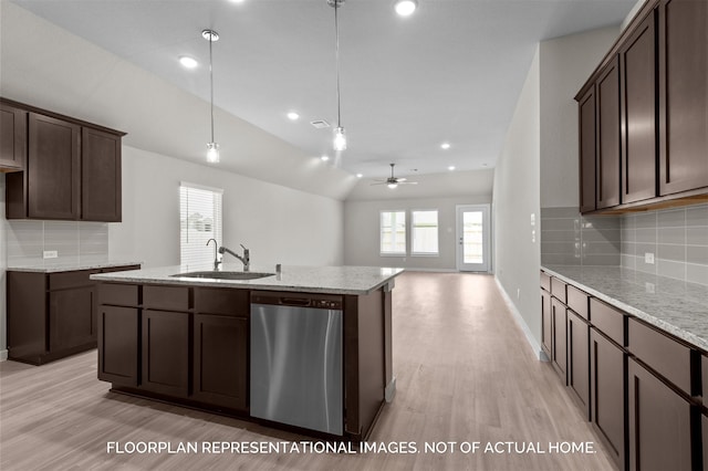 kitchen featuring light wood-style flooring, a sink, dark brown cabinets, stainless steel dishwasher, and an island with sink