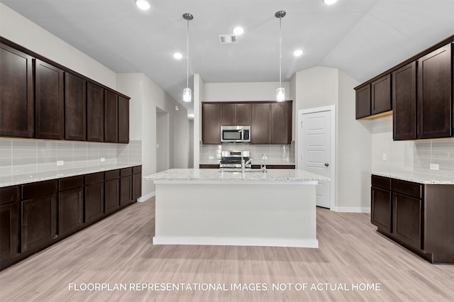 kitchen featuring appliances with stainless steel finishes, light wood-style floors, visible vents, and a sink